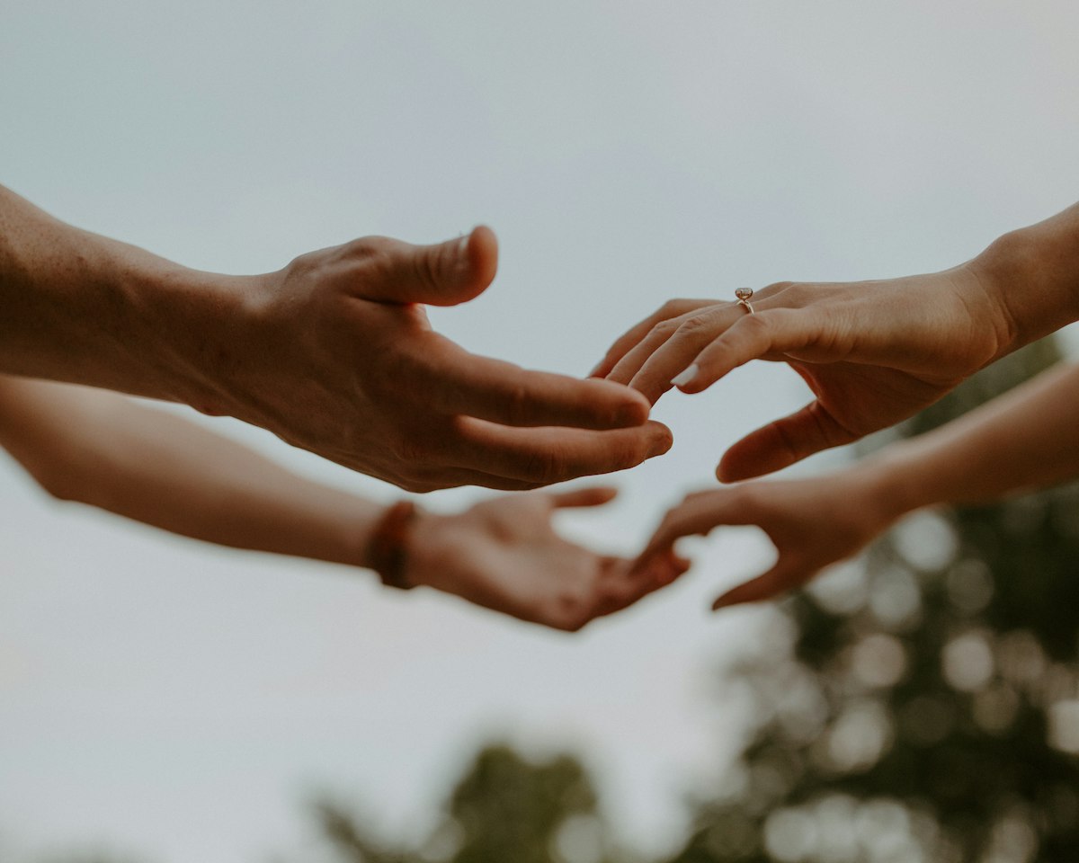 Hands reaching out to help one another