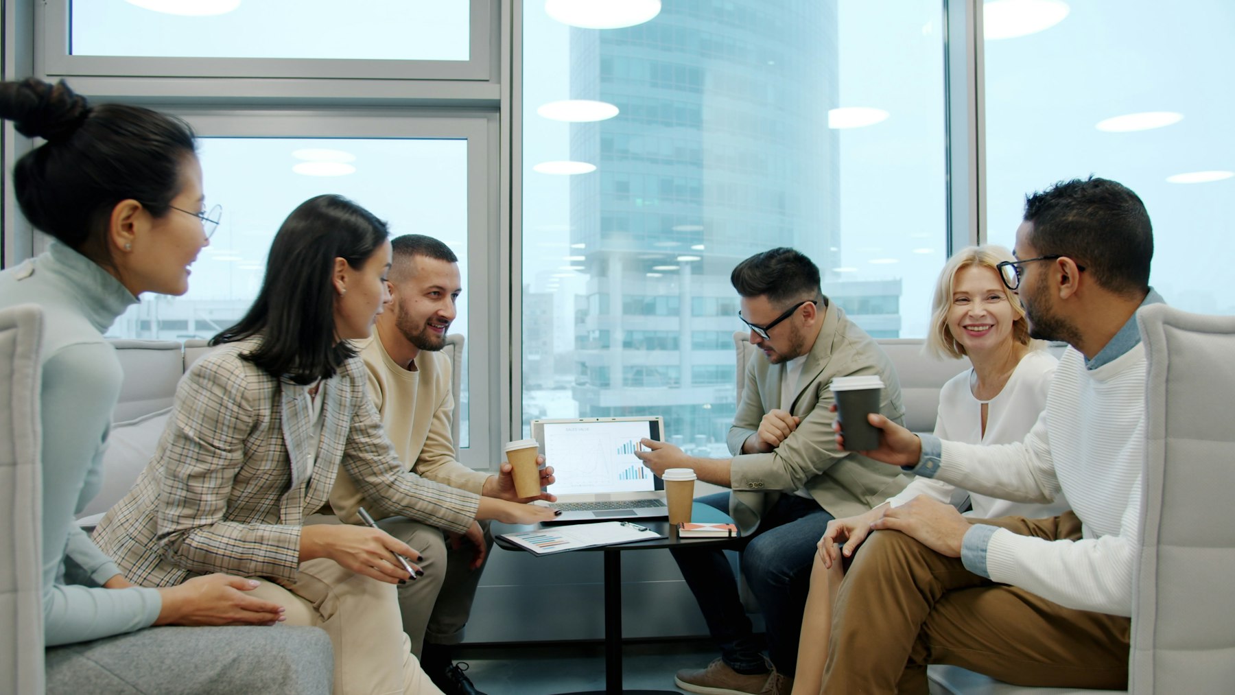 A team smiling and collaborating in an office meeting